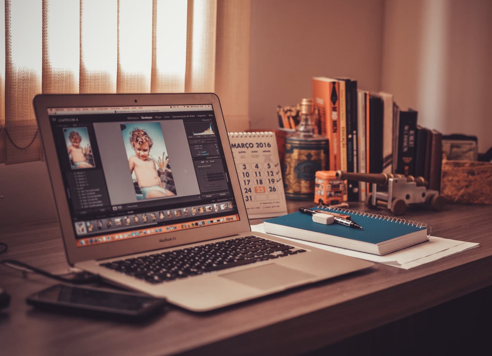 computer laptop on table displaying image of a young child